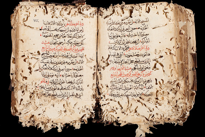 A worm-eaten Arabic manuscript.